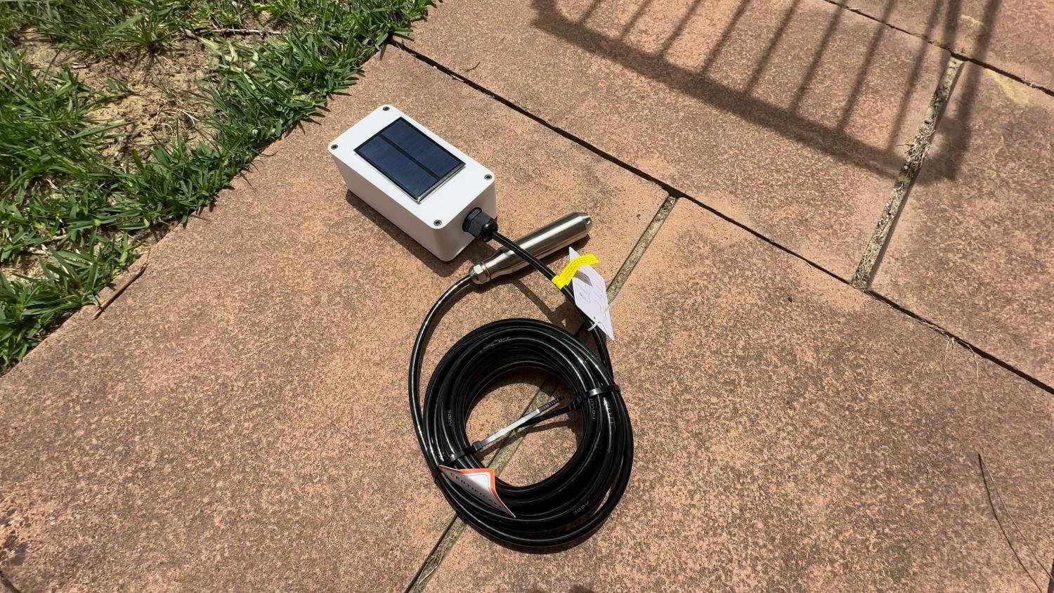 Water tank pressure sensor sitting on pavers