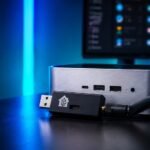 Zigbee coordinator sitting in front of a mini pc, blue moody tech lighting and home assistant screen in the background