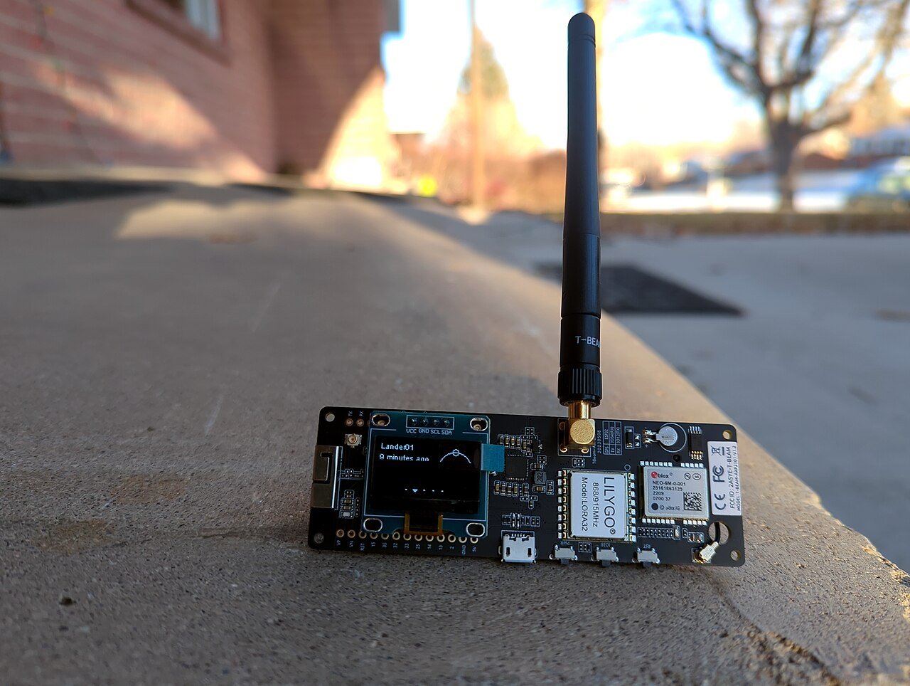 LILYGO TTGO T-Beam LoRa development board running Meshtastic with a LoRa antenna attached